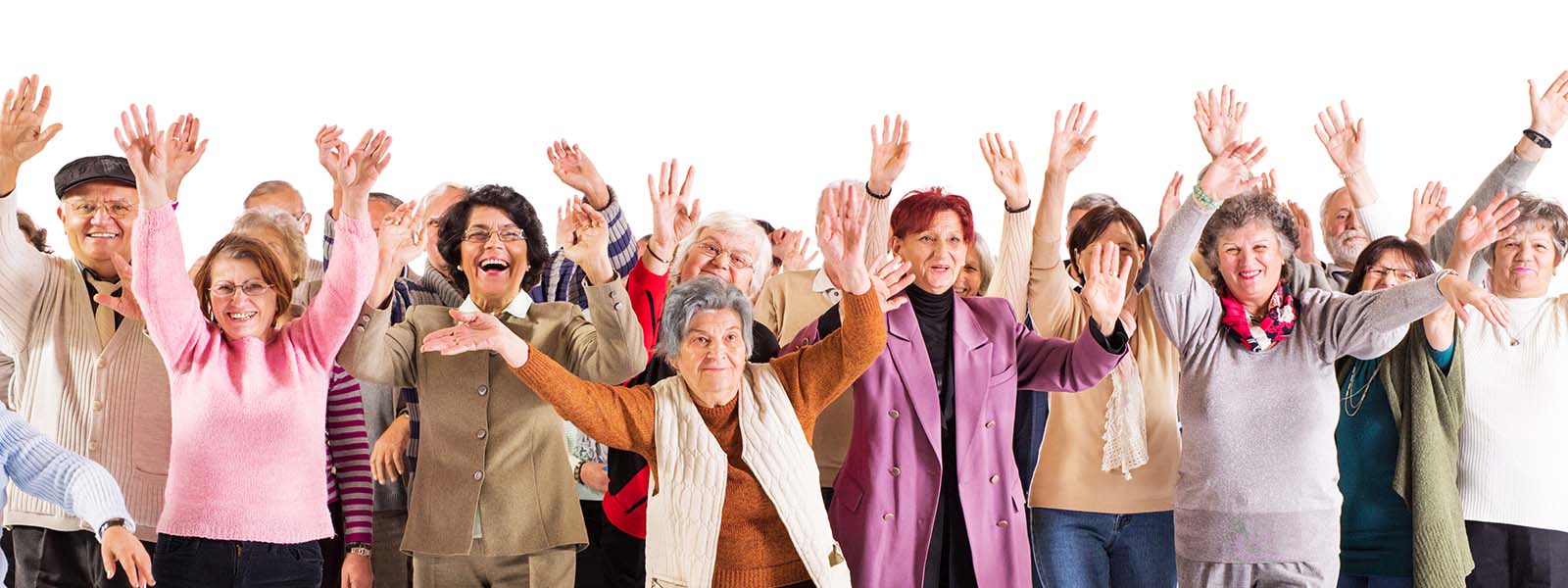 Large group of cheerful seniors with their hands raised